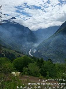 a view of a valley with a river in the mountains at Medo Guesthouse in Khashiti