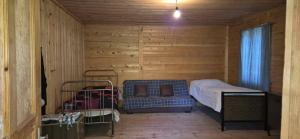 a small bedroom with a bed and a window at Medo Guesthouse in Khashiti +3 photos