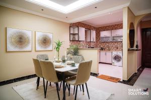 a kitchen and dining room with a table and chairs at Twleen luxury 408 in Jeddah