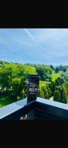 a cup sitting on a ledge with a view of trees at Antonia home in Târgu-Mureş