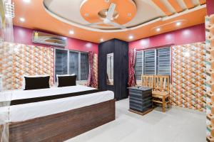 a bedroom with a large bed and a chair at Hotel O Blue Star Hotel & Restaurant in Bārāsat