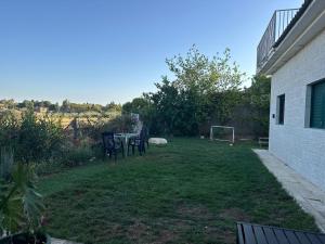 a backyard with a table and chairs and a soccer ball at Tal Shahar Extension in Tal Shaẖar +5 photos