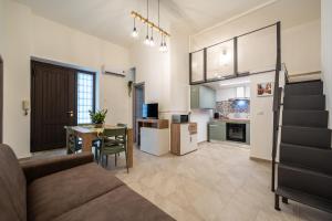 a living room and kitchen with a couch and a table at Loft San Basilio in Palermo