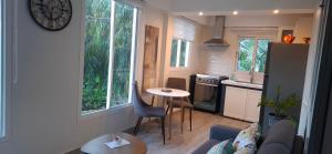 a small kitchen with a small table in a room at Flamboyant Residence 46 in Koolbaai
