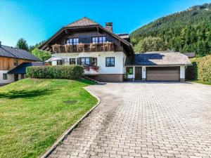 a large white house with a driveway at Ferienhaus Angerer in Obersdorf