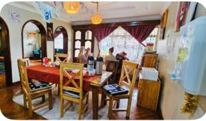 a group of people sitting at a dining room table at Giving Hands Homestay in Arusha