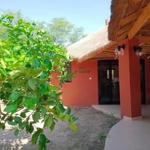 a building with a sign on the side of it at JAMNAATI Campement in Mboro +29 photos
