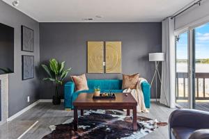 a living room with a blue couch and a table at New Renovated 5BD Home with Hot Tub Sauna & Game Rm in Prospect