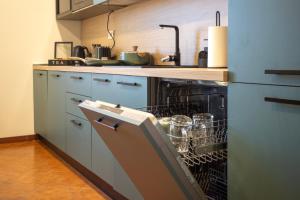 a kitchen with an open dishwasher in a kitchen at Casa Bauta in Venice