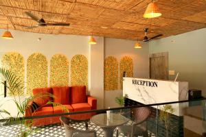 a lobby with a couch and a table and chairs at Kunj - A Boutique Hotel By Shivaneel Hospitality in Pushkar