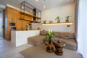 a living room with a couch and a table at Rahya Villas Complex by Iji in Uluwatu