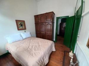 ein Schlafzimmer mit einem Bett und einer Kommode darin in der Unterkunft Casa do centro - Refúgio Colonial - Refúgio 2 in Ouro Preto