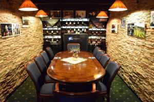 a dining room with a wooden table and chairs at Grand Hotel Residence Pieštany Adult only Boutique hotel Next to Wake Soul Beach in Piešťany +39 photos