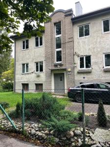 a house with a car parked in front of it at Spacious Family-friendly Apartment, Free Parking in Tallinn