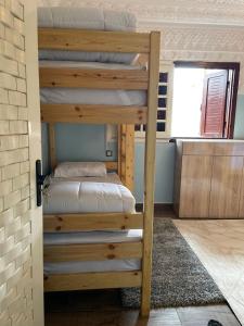 a bunk bed in a room with a bunk bed in a room at Zeri Surf Camp in Tiguemmi nʼAït Bihi