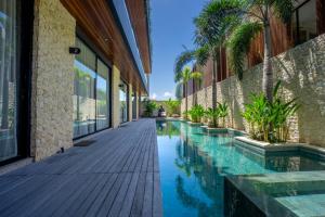 a swimming pool in the middle of a building at Rahya Villas Complex by Iji in Uluwatu