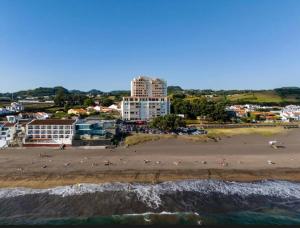 a view of a beach with people on the sand at 3 balconies with sea view - restaurants below - personalized support - Ponta Delgada -DOMOSTAY AL in Ponta Delgada