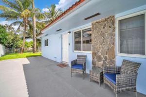 a patio with two chairs and a building at Costerra Miami 2BR in Miami