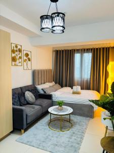 a living room with a couch and a bed at L Studio by Sella in Manila +22 photos
