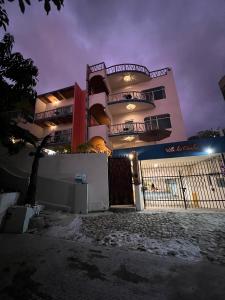 a large building with a fence in front of it at night at Villa Los Corales in Sayulita +132 photos