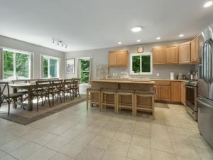 a kitchen and dining room with a table and chairs at Killington Terrace Lodge - Spacious 5BR Killington Home with 2 Kitchens, Game Room & Pet Friendly in Sherburne Center