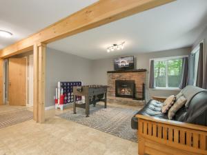 a living room with a couch and a fireplace at Killington Terrace Lodge - Spacious 5BR Killington Home with 2 Kitchens, Game Room & Pet Friendly in Sherburne Center