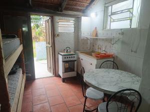 a small kitchen with a table and a stove at Apartamentos Laguna Merin Rincón del Lago in Lago Merin