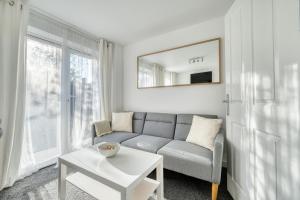 a living room with a couch and a table at Comfort Lettings - 4 bedroom, 8 Beds & 2 Free Parking, Garden, Family and Workers Friendly in Market Harborough