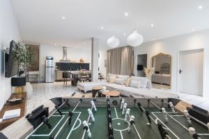 a living room with a pool table in the middle at Loft Station Parking Video Projector near Tours in Saint-Pierre-des-Corps