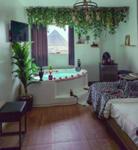 a room with a tub with a pyramid in the window at Pyramids ICON 4 & 5 in Cairo