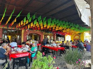 a group of people sitting at tables in a restaurant at Hotel Leilani in San Andrés Sinaxtla