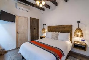 Ένα ή περισσότερα κρεβάτια σε δωμάτιο στο Casa Yuca Hotel Boutique