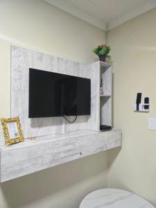 a flat screen tv on a wall in a bathroom at Peshline Guest House Unit 3 in Ermelo