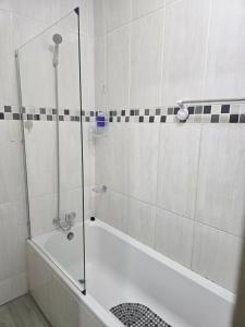 a bathroom with a shower and a bath tub at Peshline Guest House Unit 3 in Ermelo