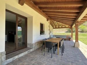 a patio with a wooden table and chairs on it at Casa Rural Elizalde 