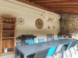 a dining room with a blue table and chairs at Brin d'Ardèche in Saint-Prix +16 photos