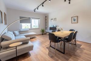 a living room with a couch and a table at 2BR at Artist's Palace - Skanderbeg Square Views in Tirana +19 photos