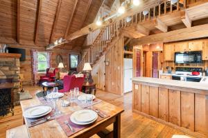 a dining room and kitchen in a log cabin at Romantic Cabin Getaway - King Bed - Fast Wi-Fi - Pet-Friendly in Meadows of Dan
