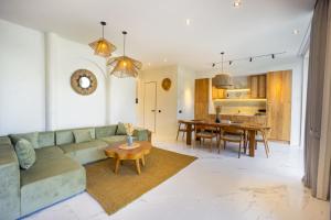 a living room with a couch and a table at White Residence by Iji in Uluwatu