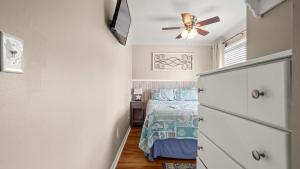 a bedroom with a bed and a ceiling fan at Great Vibes in Panama City Beach +44 photos
