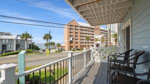 a balcony with two chairs and a street at Great Vibes in Panama City Beach