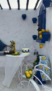 a table and chairs with a cake on it at Casa Élan for VIP guests 2 Pools in Ras al Khaimah