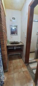 a bathroom with a sink and a mirror at Chales praias de Ubatuba in Ubatuba +191 photos