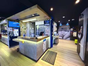 a store with a counter in the middle of a room at ibis Budget Beaune in Beaune
