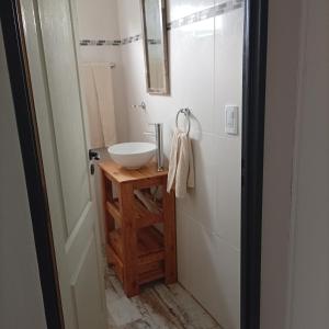 a bathroom with a sink and a mirror at El Refugio Tapalque in Tapalqué
