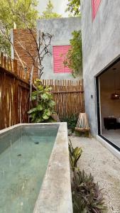 a swimming pool in the backyard of a house at The Heart of the City Room 3 in Mérida