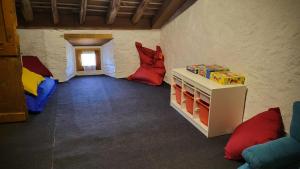 a room with two beds and a table in a room at La casa del jardì - Jardin clos, WIFI, authentique in Angoustrine