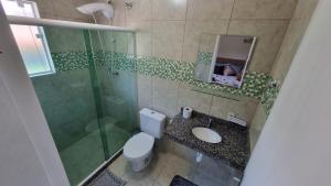 a bathroom with a toilet and a shower and a sink at casa da cris in Miguel Pereira +7 photos