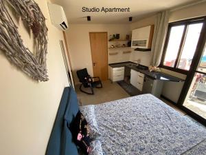 a bedroom with a bed and a desk in a room at Crown Paradise Beach Lagoon Studio in Sal Rei