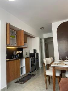 a kitchen with a table and a dining room at Shamzluxury2 in Nairobi